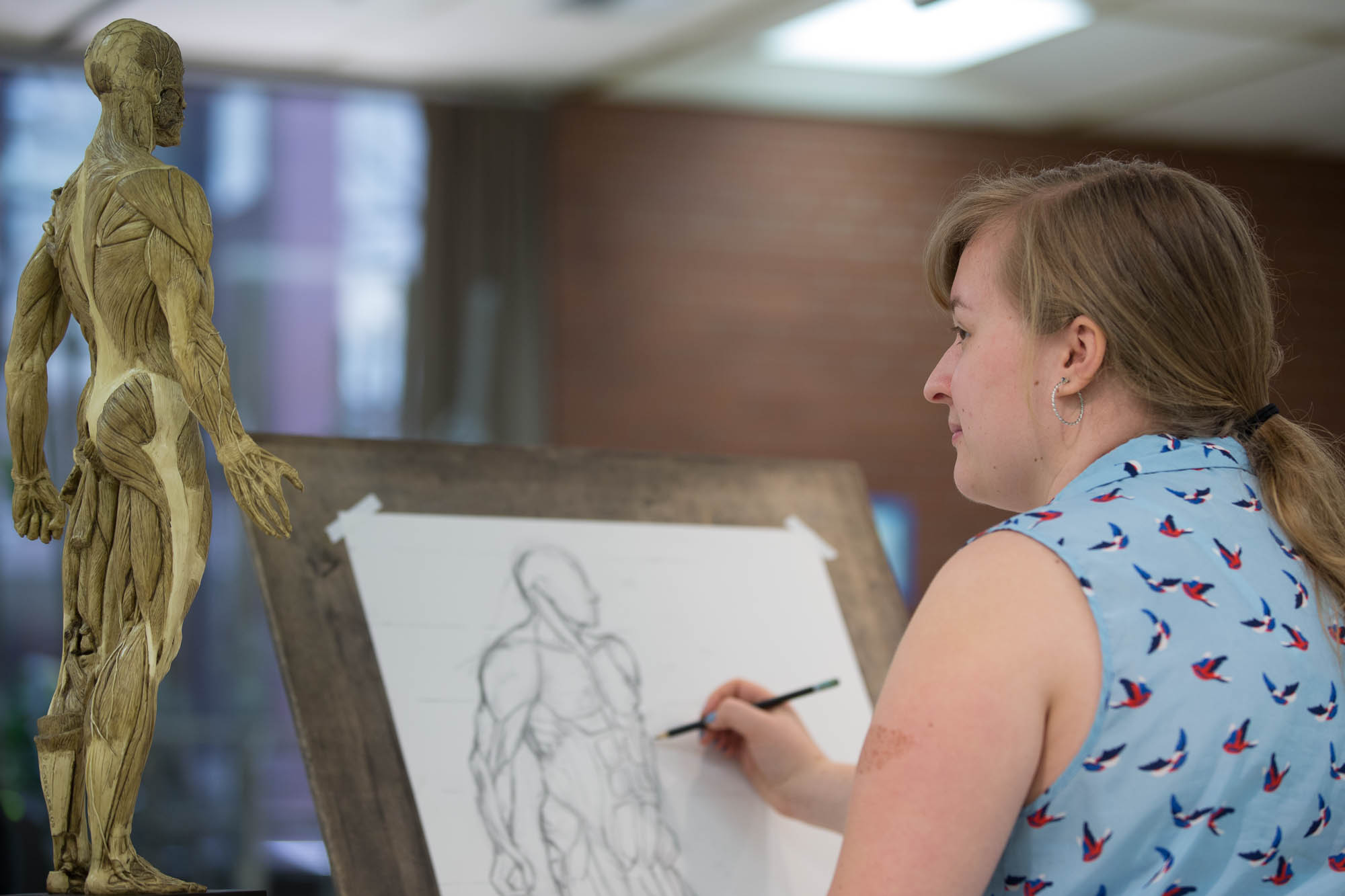 Student sketching in a classroom